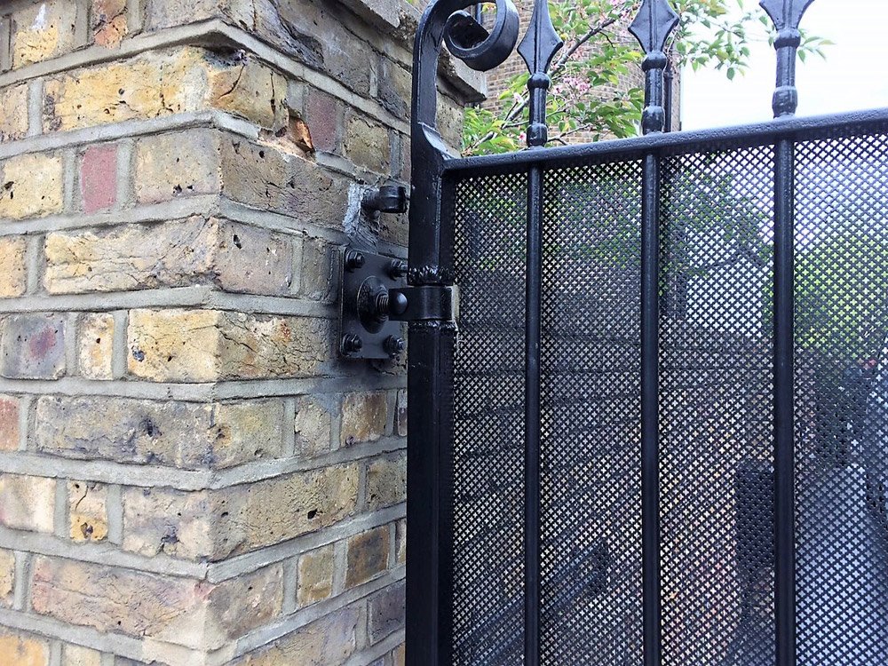 A residential automatic gate, showing upgraded hinges to incorporate the latest safety standards.